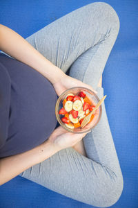 High angle view of woman holding bowl