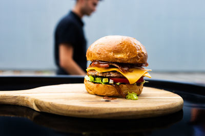 Chef cooking burger on cutting board