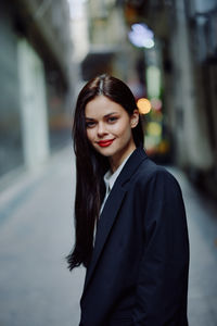 Portrait of young woman standing outdoors