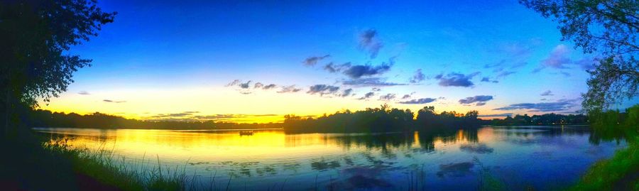 Scenic view of lake against sky at sunset