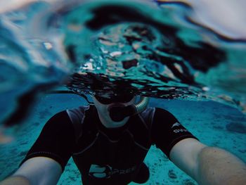 Midsection of woman swimming in sea