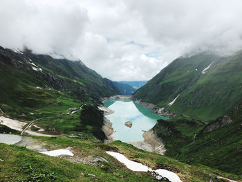 Scenic view of lake amidst mountains against sky