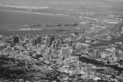 High angle view of cityscape by sea against sky