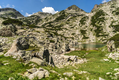 Scenic view of lake and mountains against sky