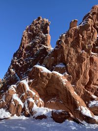 Low angle view of rocks against sky during winter