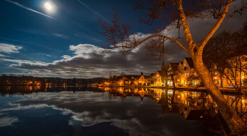 Scenic view of lake against sky at night