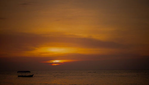 Scenic view of sea against orange sky