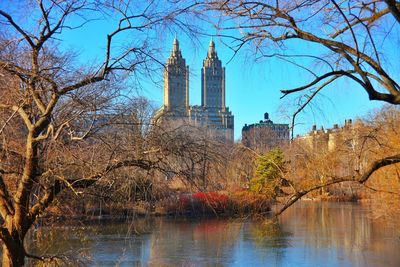 Modern buildings in front of river and trees at central park