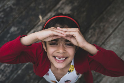 Portrait of a smiling girl covering face