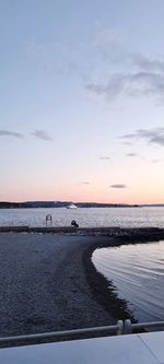 Scenic view of beach against sky during sunset