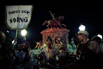 Men in illuminated traditional clothing