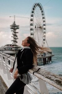 Woman with wind in her hair on the beach.