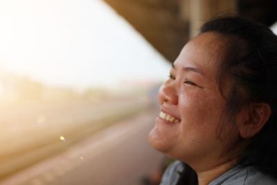 Close-up of smiling woman looking away