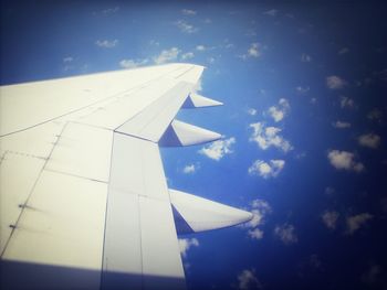 Airplane wing against blue sky