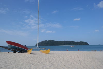 Scenic view of beach against blue sky