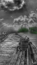 Bench on land against sky