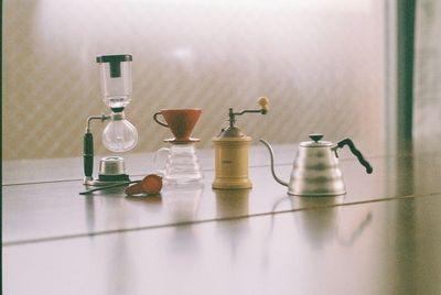 Close-up of glass bottles on table at home