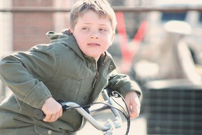 Portrait of boy sitting outdoors