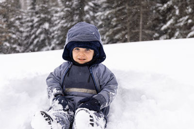 Portrait of woman skiing on snow covered field