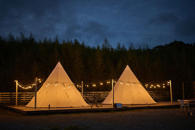 View of illuminated tent against sky at night