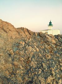 View of lighthouse on mountain against sky