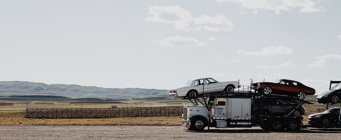 View of vehicles on road against sky