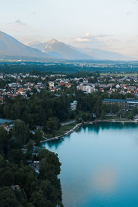 High angle view of townscape by river against sky