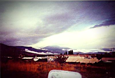 Scenic view of mountains against cloudy sky