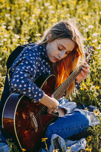 Young woman playing guitar