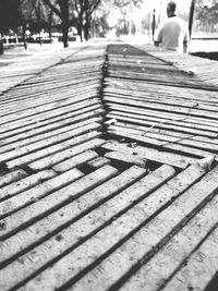 Close-up of person walking on cobblestone