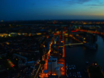 Illuminated cityscape against sky at night