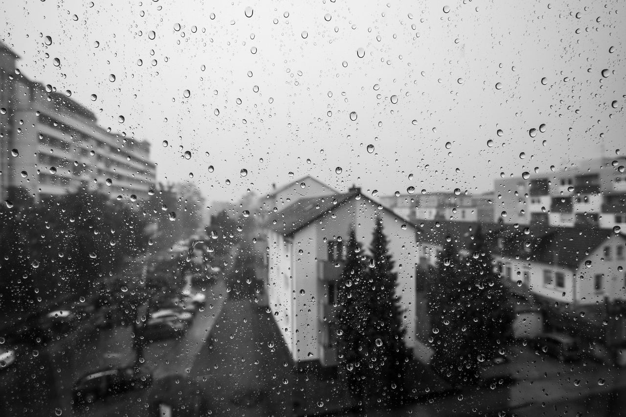 CITY SEEN THROUGH WET GLASS WINDOW