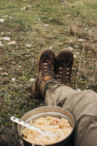 Low section of man with vegetables on field