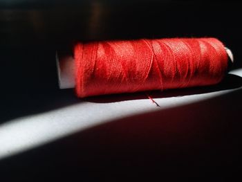 Close-up of red water on table against black background