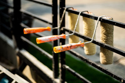 Row of paint roller cover hung on a black rail, after using and cleaning to wait for the next use.