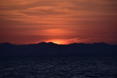 Scenic view of sea against romantic sky at sunset