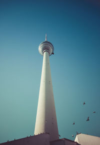 Low angle view of fernsehturm against clear blue sky