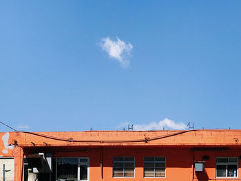 Low angle view of buildings against blue sky