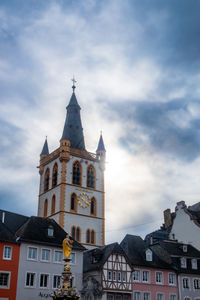 Low angle view of building against cloudy sky