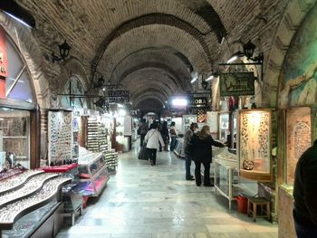 People in illuminated corridor