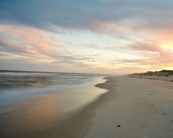 Scenic view of beach against sky during sunset