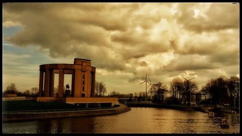 Bridge over river against sky during sunset