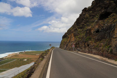 Road by sea against sky