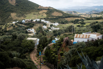 High angle view of houses and mountains against sky