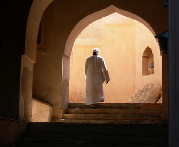 Rear view of man standing in historic building