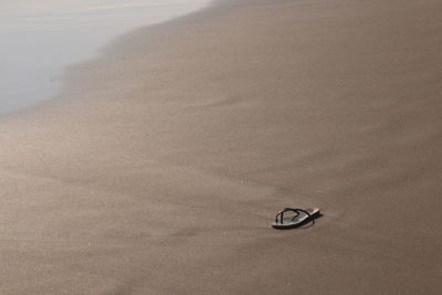 High angle view of shoes on beach