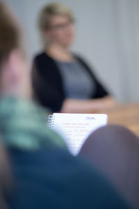 Close-up of woman standing on bench