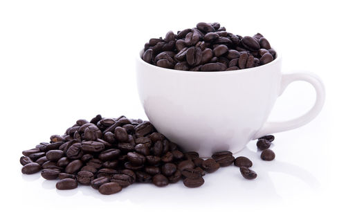 Close-up of coffee beans against white background