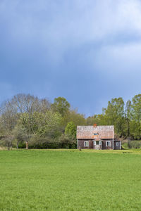 Built structure on field against sky
