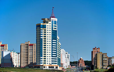 Low angle view of buildings against clear blue sky